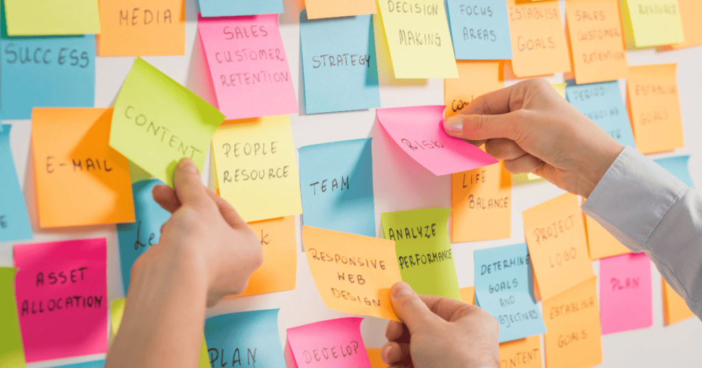 Sticky notes showing all the things needed to brainstorm when working with a designer